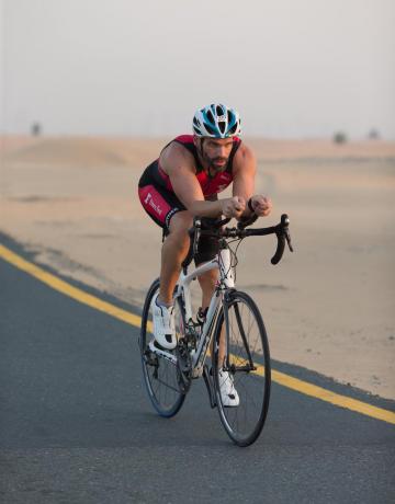 Fitness First member riding a bicycle Fitness First member riding a bicycle