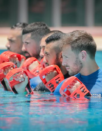 Pool Classes Men exercising in swimming pool