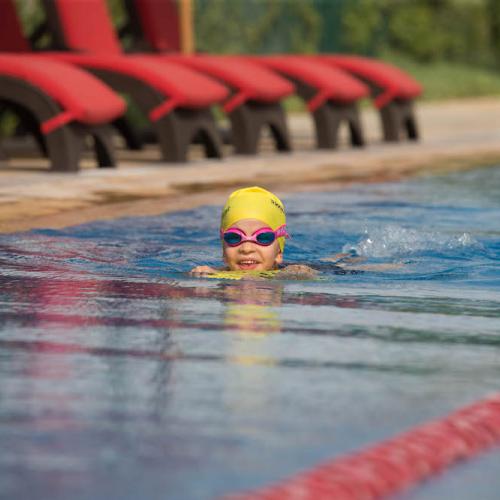 kid swimming in Fitness First outdoor pool
