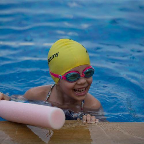 happy kid in a swimming class