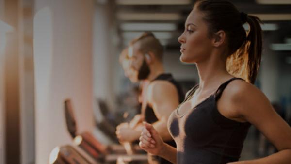 Female Gym member running on treadmill in Fitness First UAE