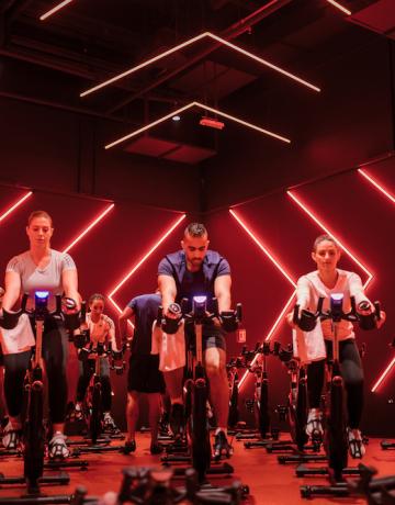 Fitness First members exercising on watt bikes