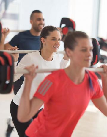 Weight bar squat group exercise Weight bar squat group exercise