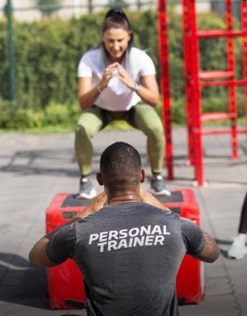personal trainer coaching on squat exercise personal trainer coaching on squat exercise