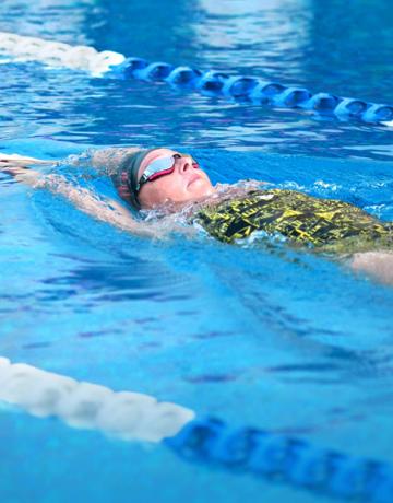 Fitness First member back swimming