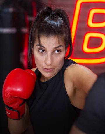 Female Fitness First member during boxing training session Female Fitness First member during boxing training session