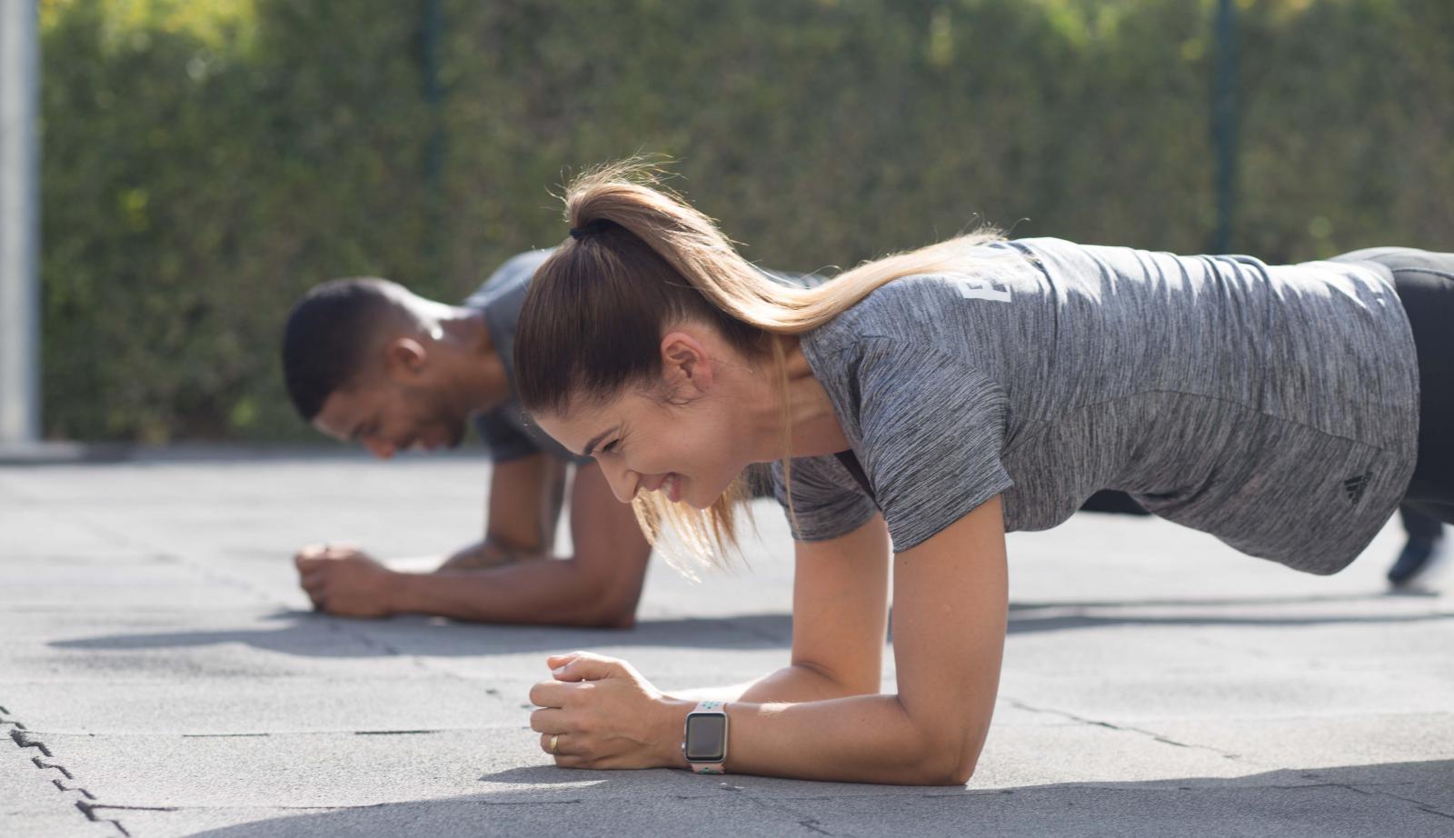 personal trainers during a push-up workout personal trainers during a push-up workout